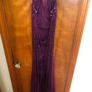 Plum colored prom dress. Cross and opened back, floor length dress.